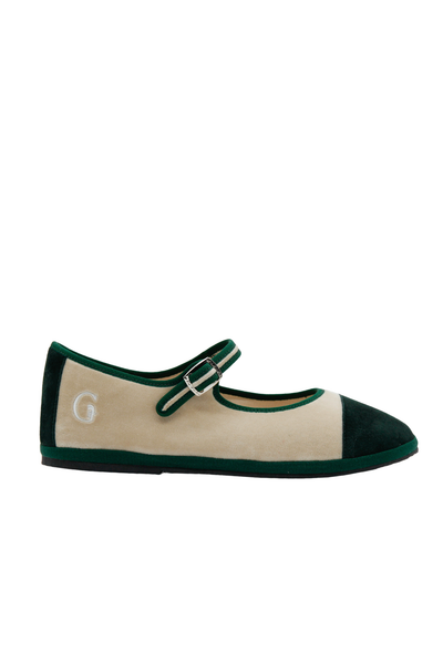 A single Mary Jane flat shoe in beige suede and dark green velvet, featuring a green strap with a silver buckle and a white embroidered letter 'G' on the heel, shown against a plain white background.